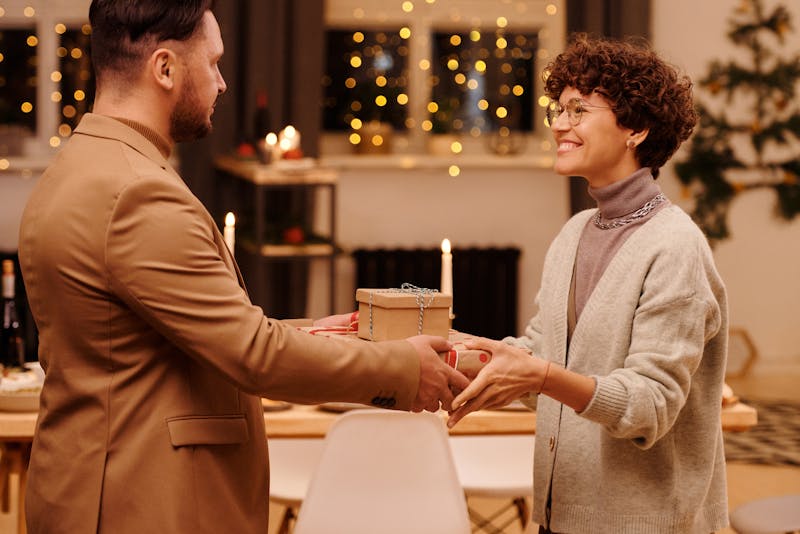 a man giving his wife some gifts